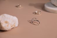 Silver Rings on White Textile