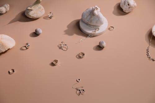 Photo of Rings and Earrings on a Brown Surface