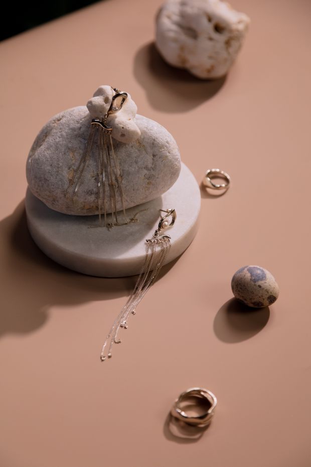 Petal-shaped studs arranged on pale stones — photo by cottonbro studio on Pexels