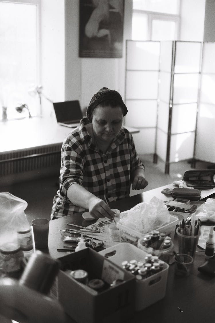 A Woman Painting In A Studio