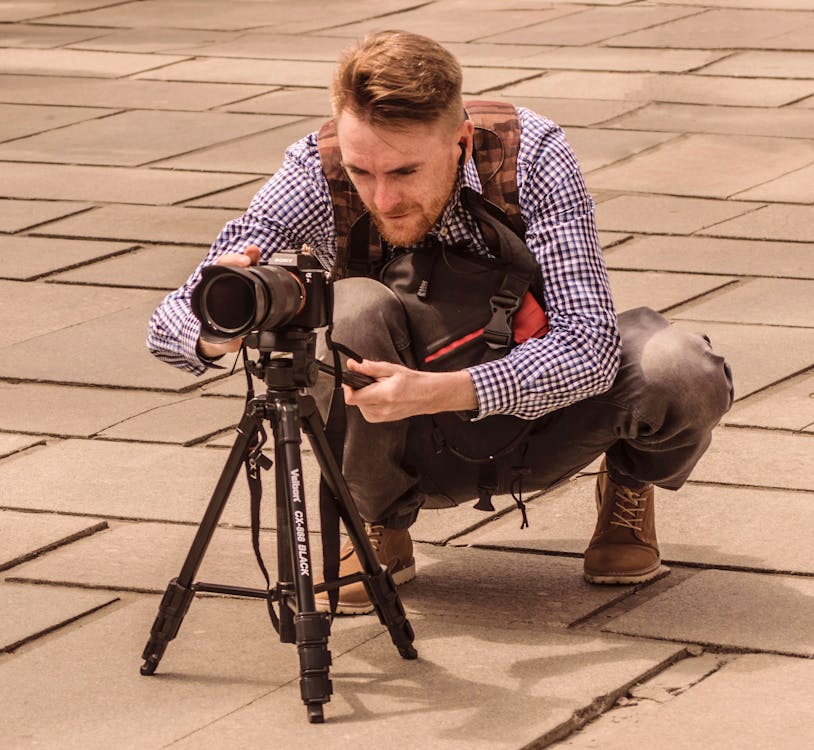 Man setting up a Camera · Free Stock Photo
