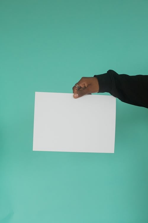 Person Holding White Printer Paper