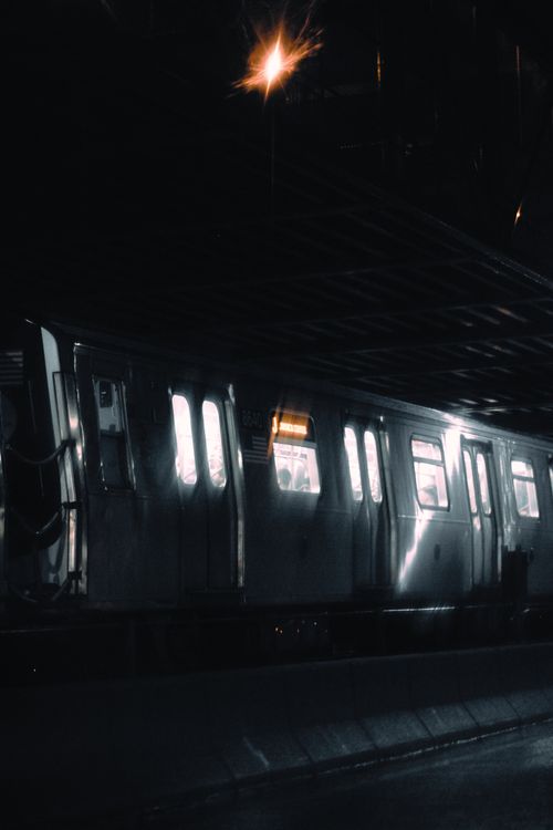 Free Atmospheric view of a train at night, highlighting urban nocturnal travel. Stock Photo