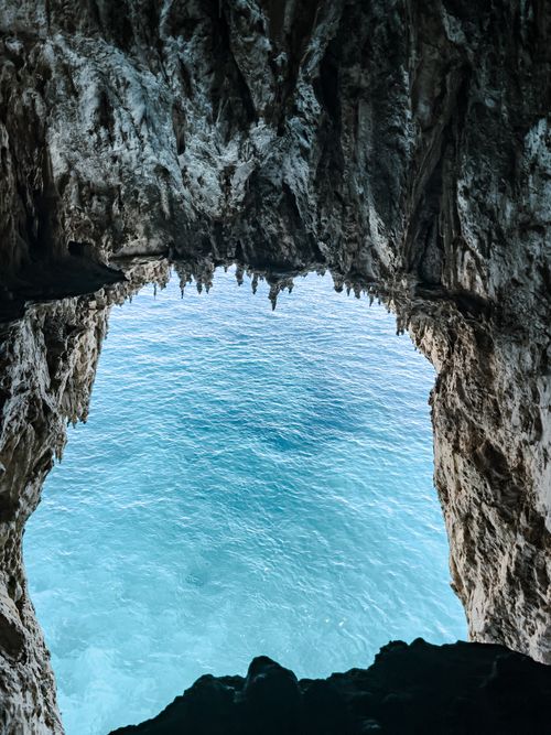 Free Breathtaking ocean view through a natural sea cave, capturing serene blue waters. Stock Photo