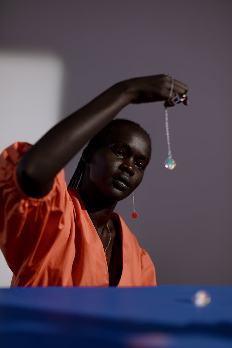 A Woman Looking At A Necklace