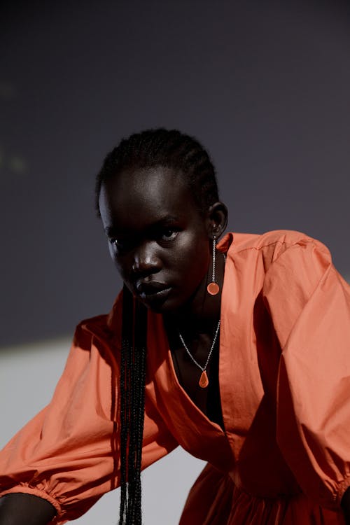 Close-Up Shot of a Woman in Orange Outfit
