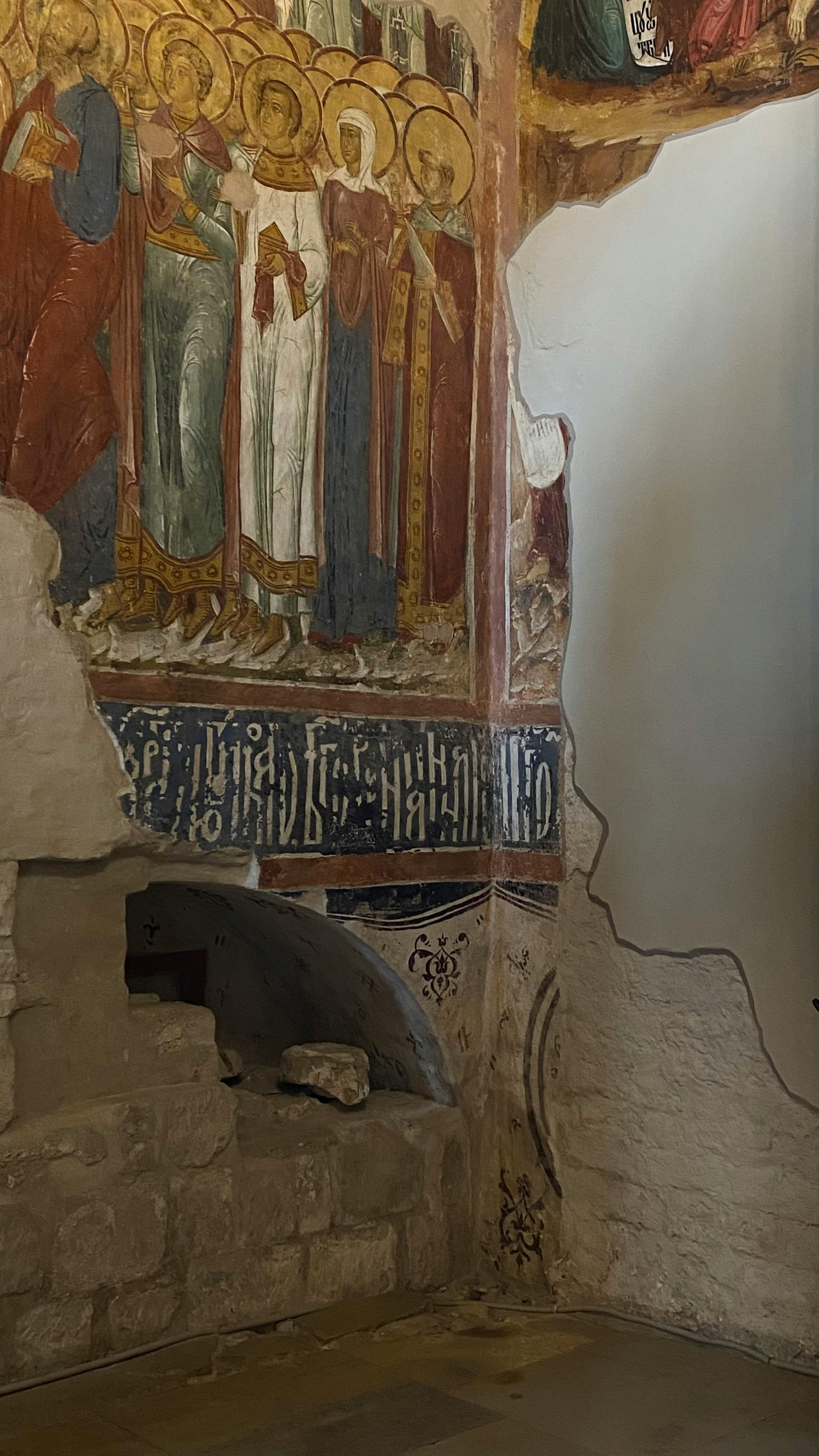 Ancient church fresco showcasing religious figures and artwork.