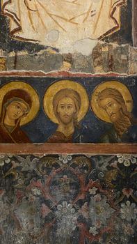 Detailed view of an ancient orthodox fresco depicting religious figures, rich in history.