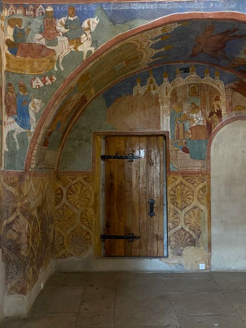 Free Arched doorway with vibrant religious fresco in a historic setting. Stock Photo