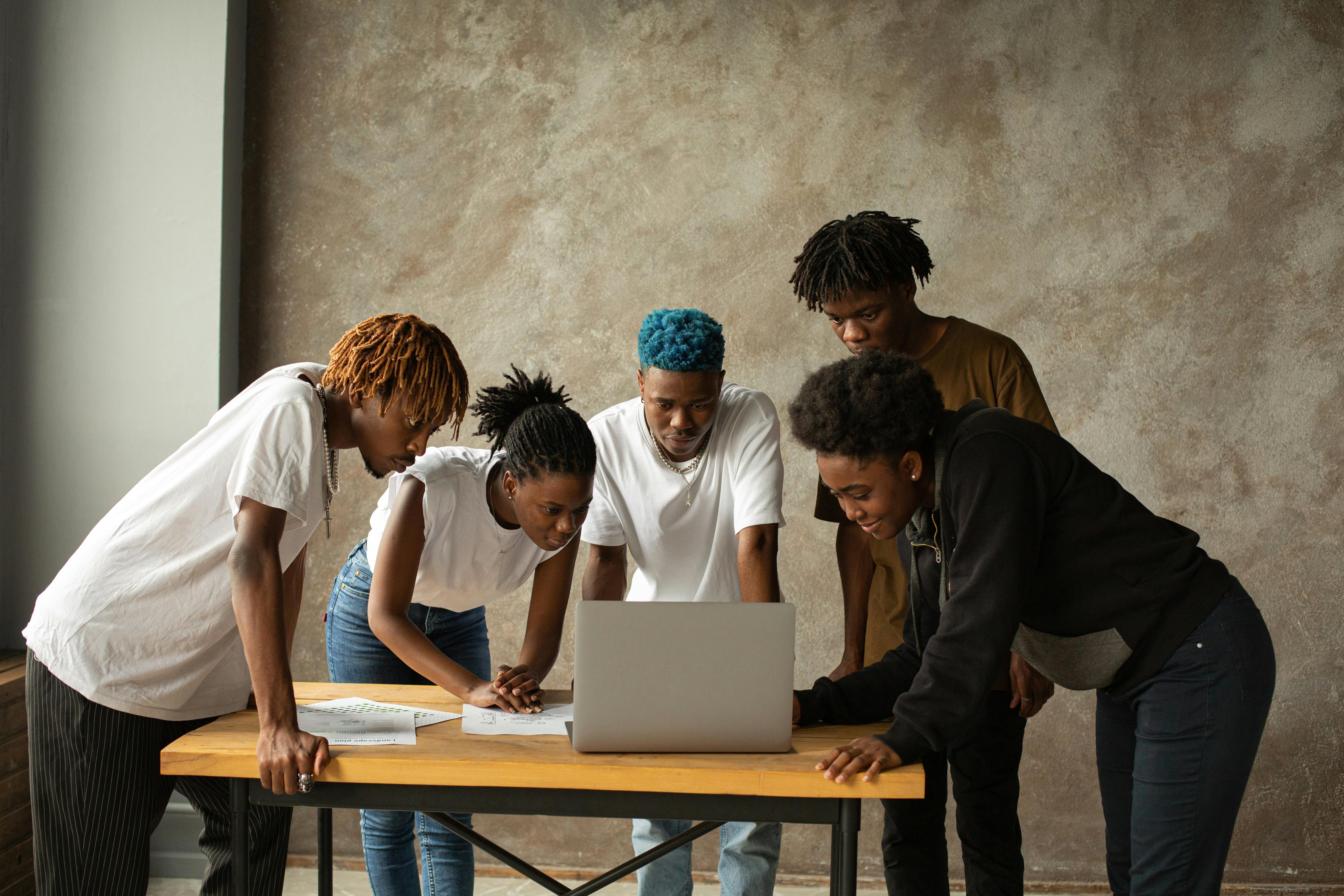 colleagues looking at a laptop on the desk