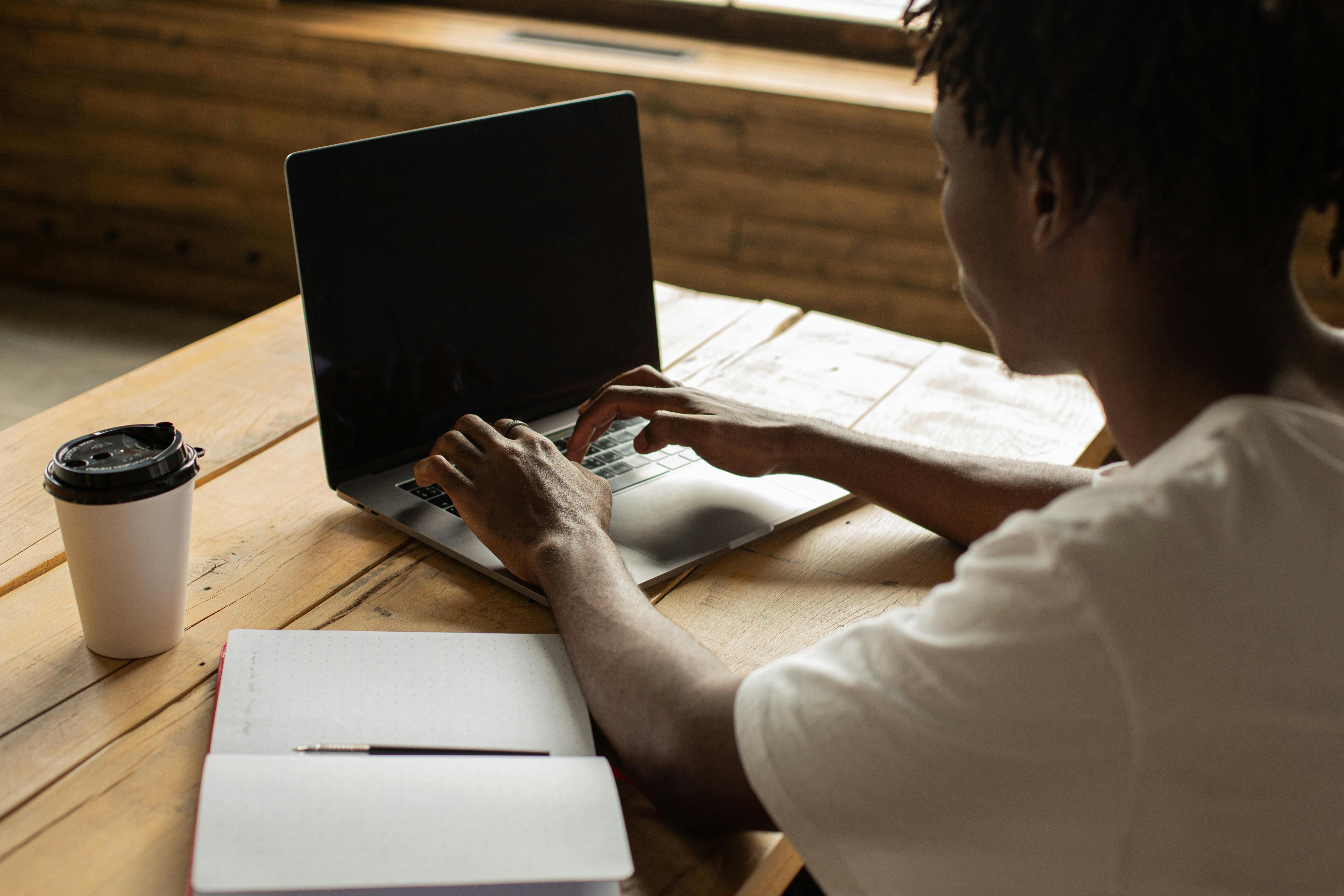 Person Using a Laptop on Lap · Free Stock Photo