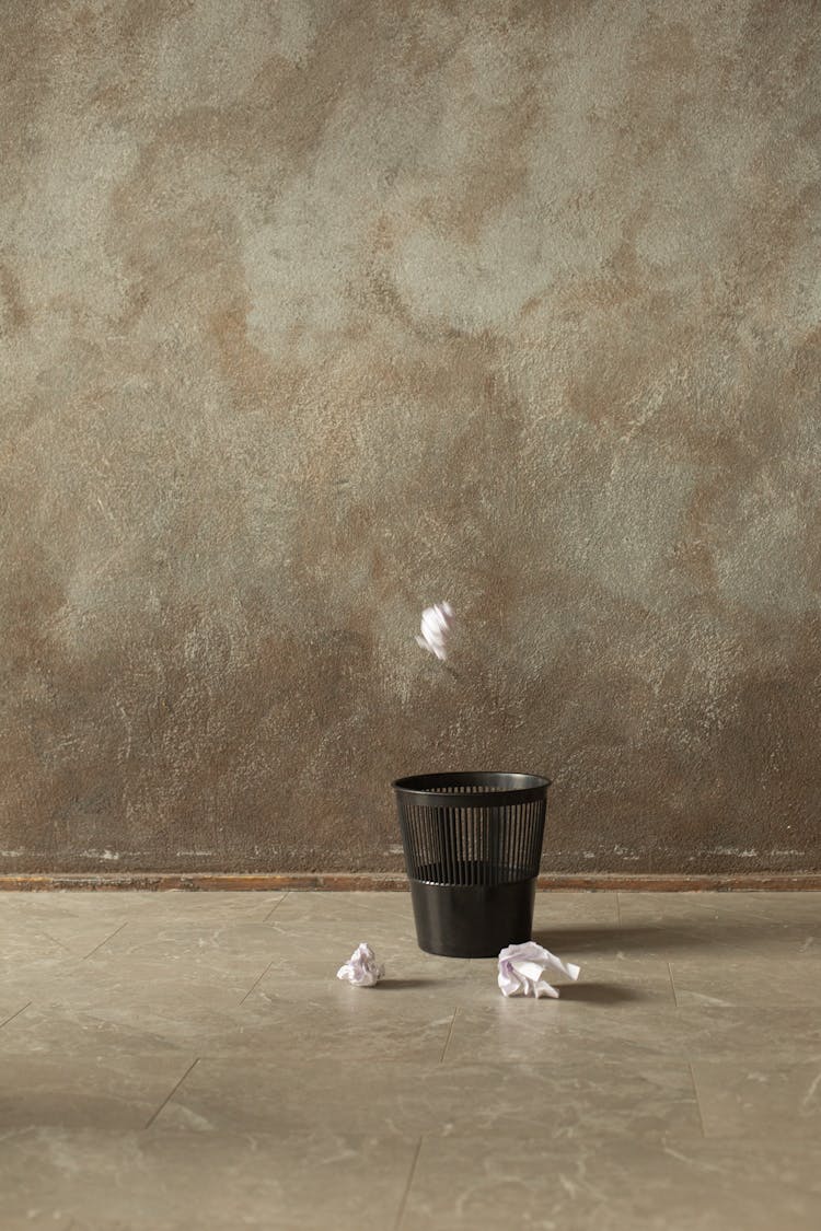 Throwing Of Crumpled Paper On A Trash Bin 