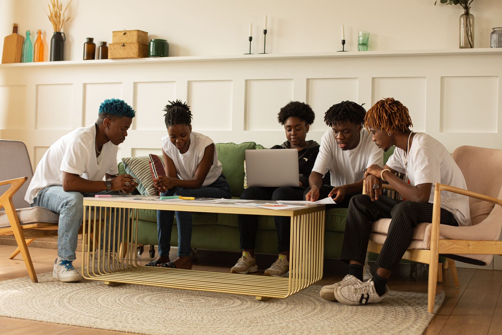 Community members gathered around a table for a wellness conversation with tea and journals
