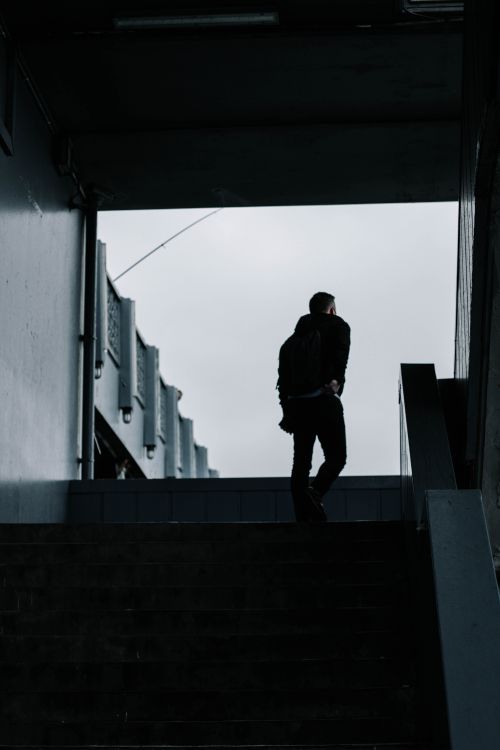 Free Silhouetted man walking up stairs in urban tunnel setting, Istanbul. Stock Photo