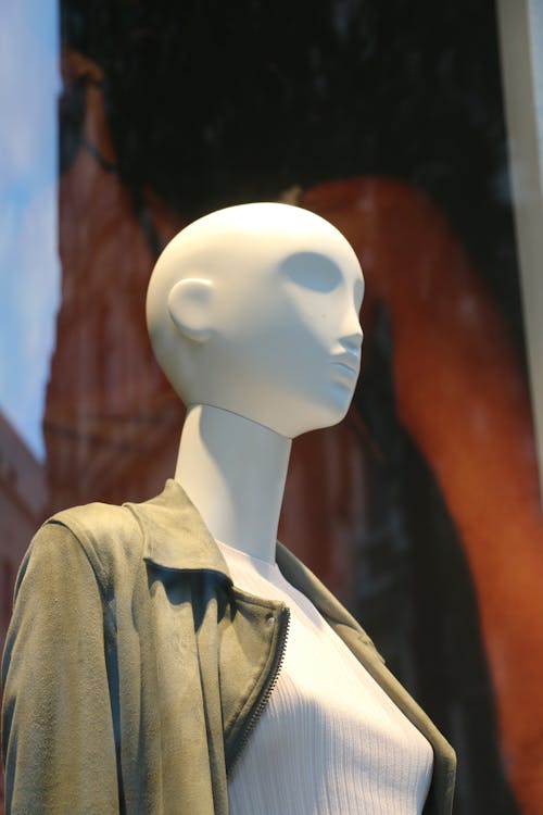 White Mannequin Wearing a Brown Jacket