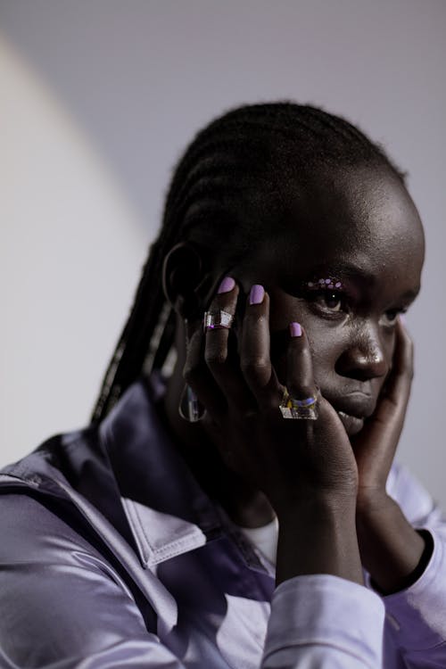 Woman in Lilac Long Sleeves with Hands on Cheeks