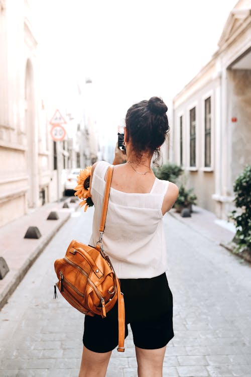 Back View of a Woman Carrying a Leather Backpack