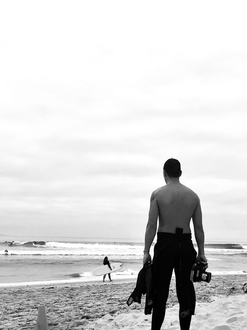 Free Monochrome photo of a surfer at Malibu beach, capturing the serene seaside scene. Stock Photo