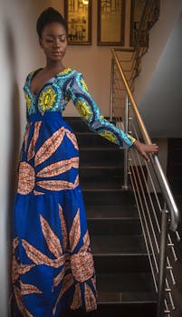 Stunning portrait of a woman in a colorful dress on an indoor staircase.