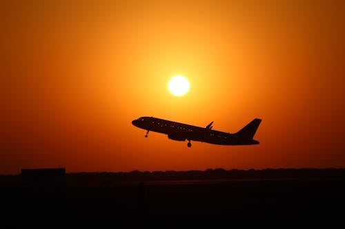 Silhouette of Airplane during Sunset