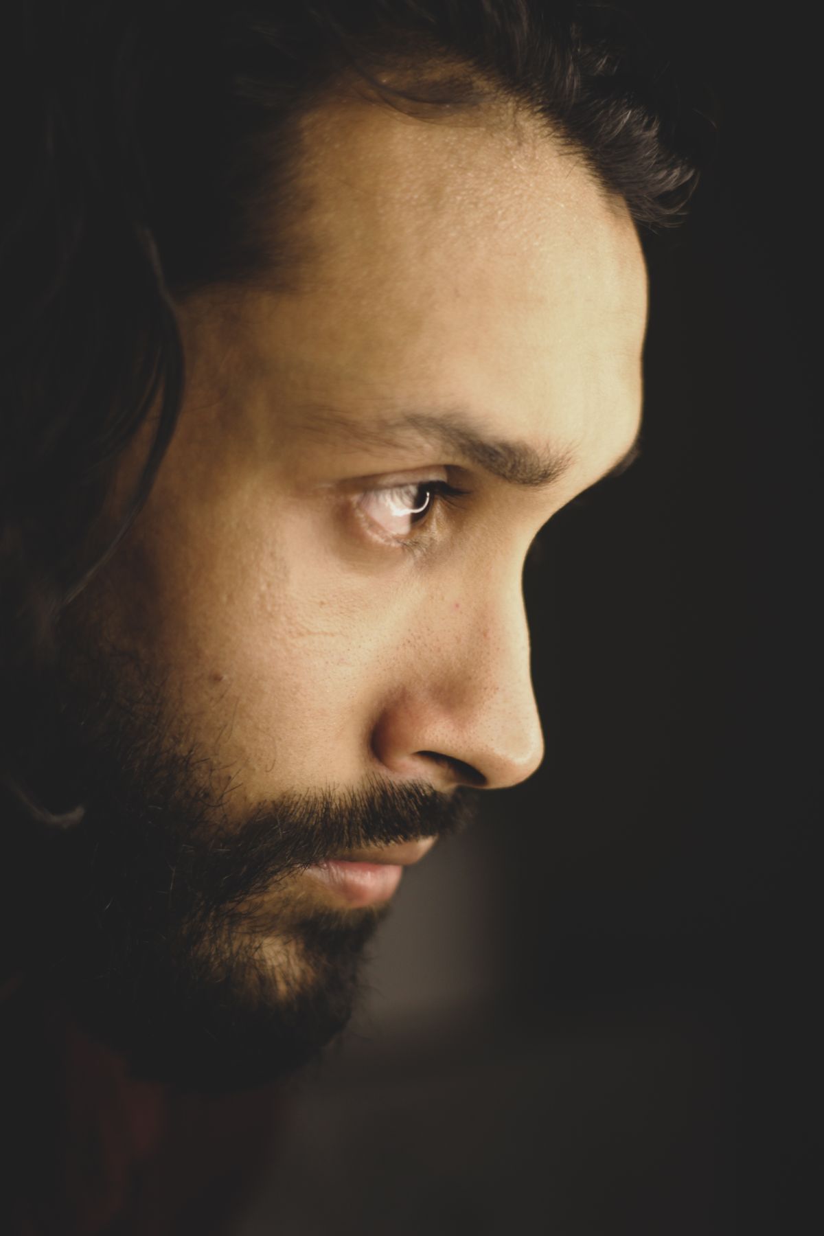 Side profile of a man with a shaped beard