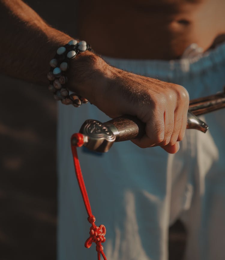 Person Holding Sword Handle In Tilt Shift Lens 