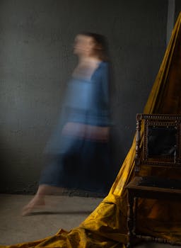 Artistic long exposure shot of a woman's blurred movement indoors.