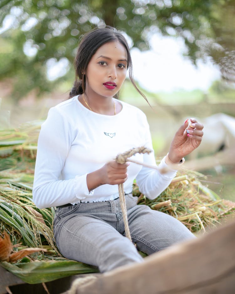 Woman Sitting On Hay Riding Cart