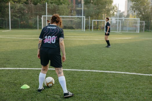 Female soccer players preparing for a match on a lush green field.