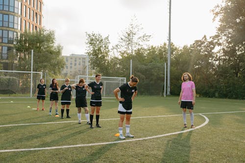 Free Group of People Playing Standing on a Soccer Field Stock Photo