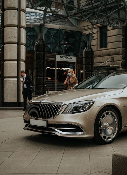 Free A luxury Mercedes Benz parked outdoors in Moscow with people in the background, urban lifestyle shot. Stock Photo