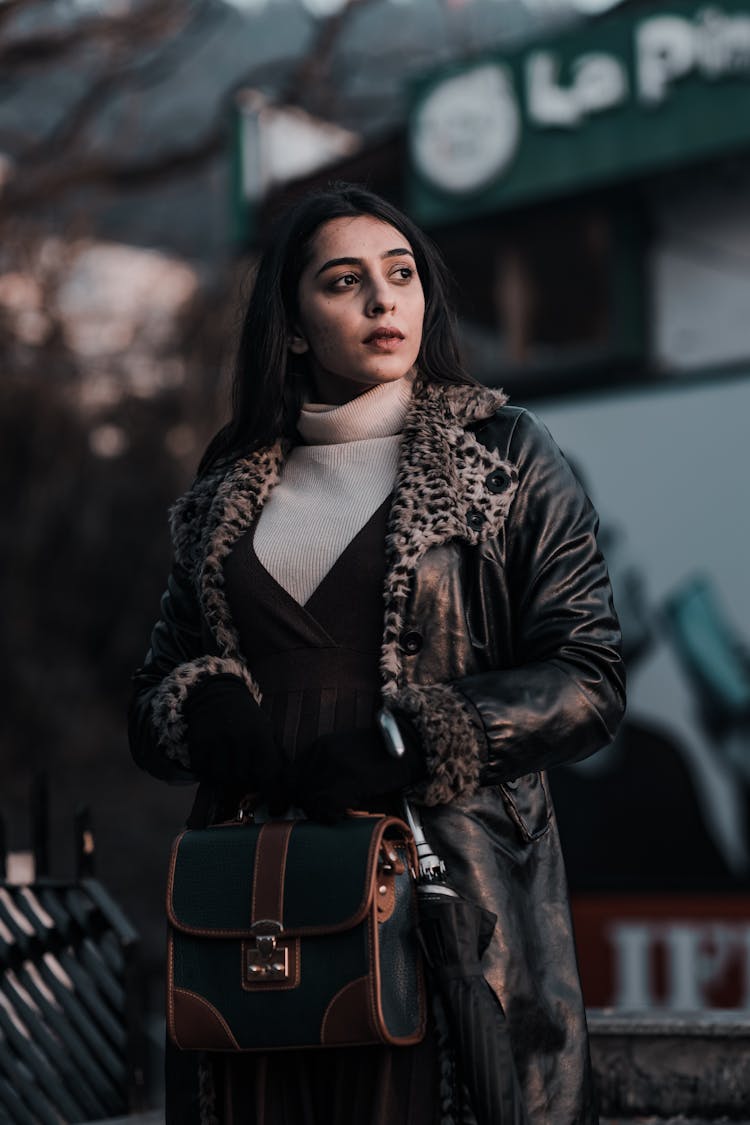 Woman In Black Leather Coat Holding Her Handbag