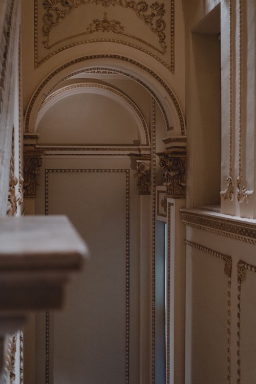 Free A luxurious interior corridor featuring intricate architectural details and ornate archways. Stock Photo
