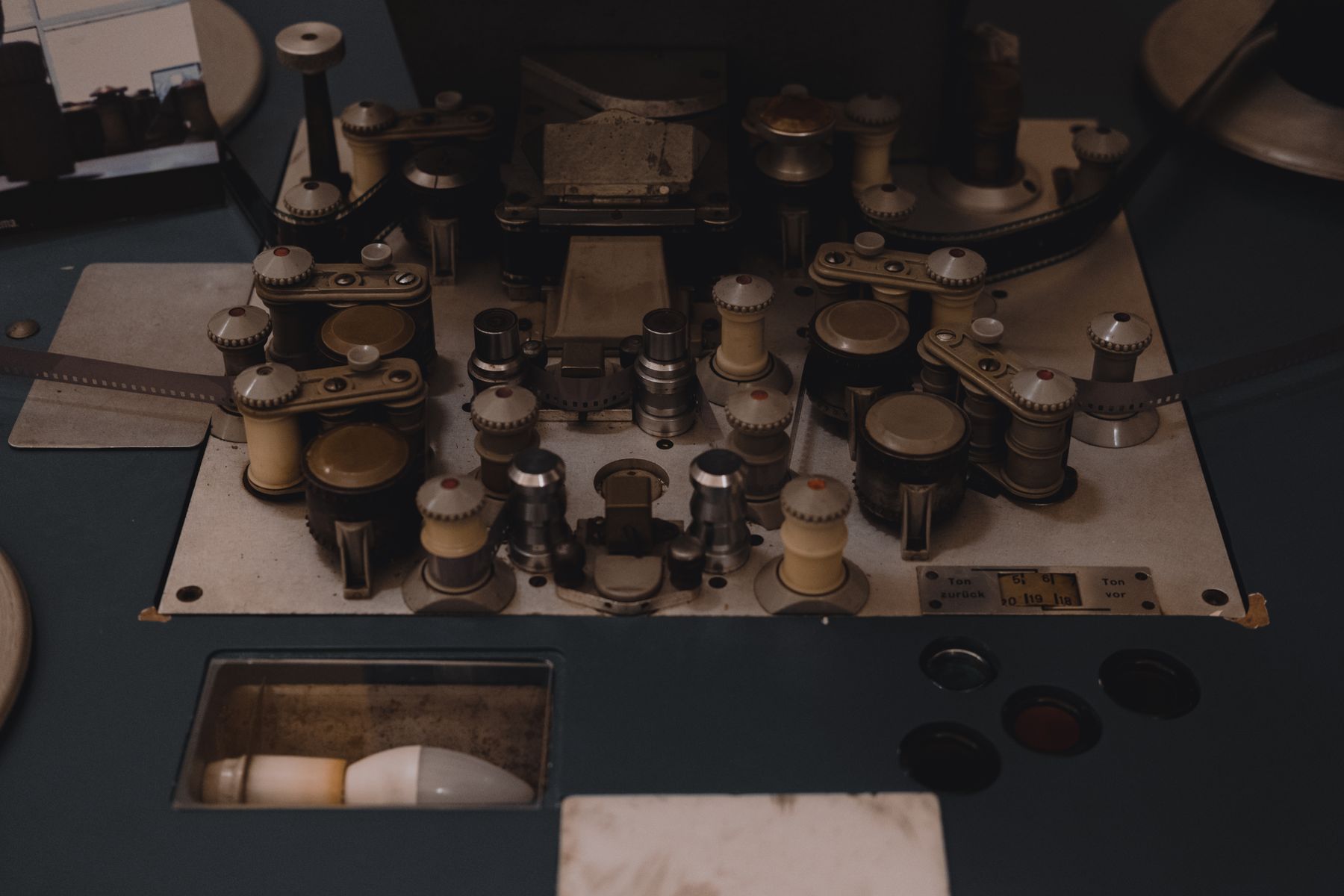 Close-up of vintage film editing equipment with knobs and reels.