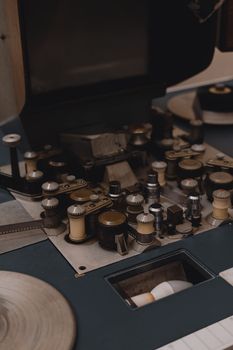 Close-up of a vintage film editing machine with intricate gears and film rolls.