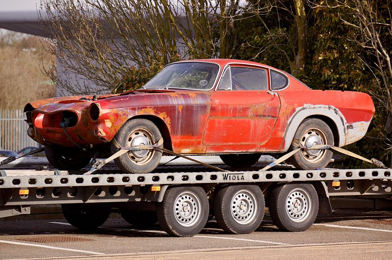 Damaged car secured on a flatbed tow truck during accident recovery in Syracuse