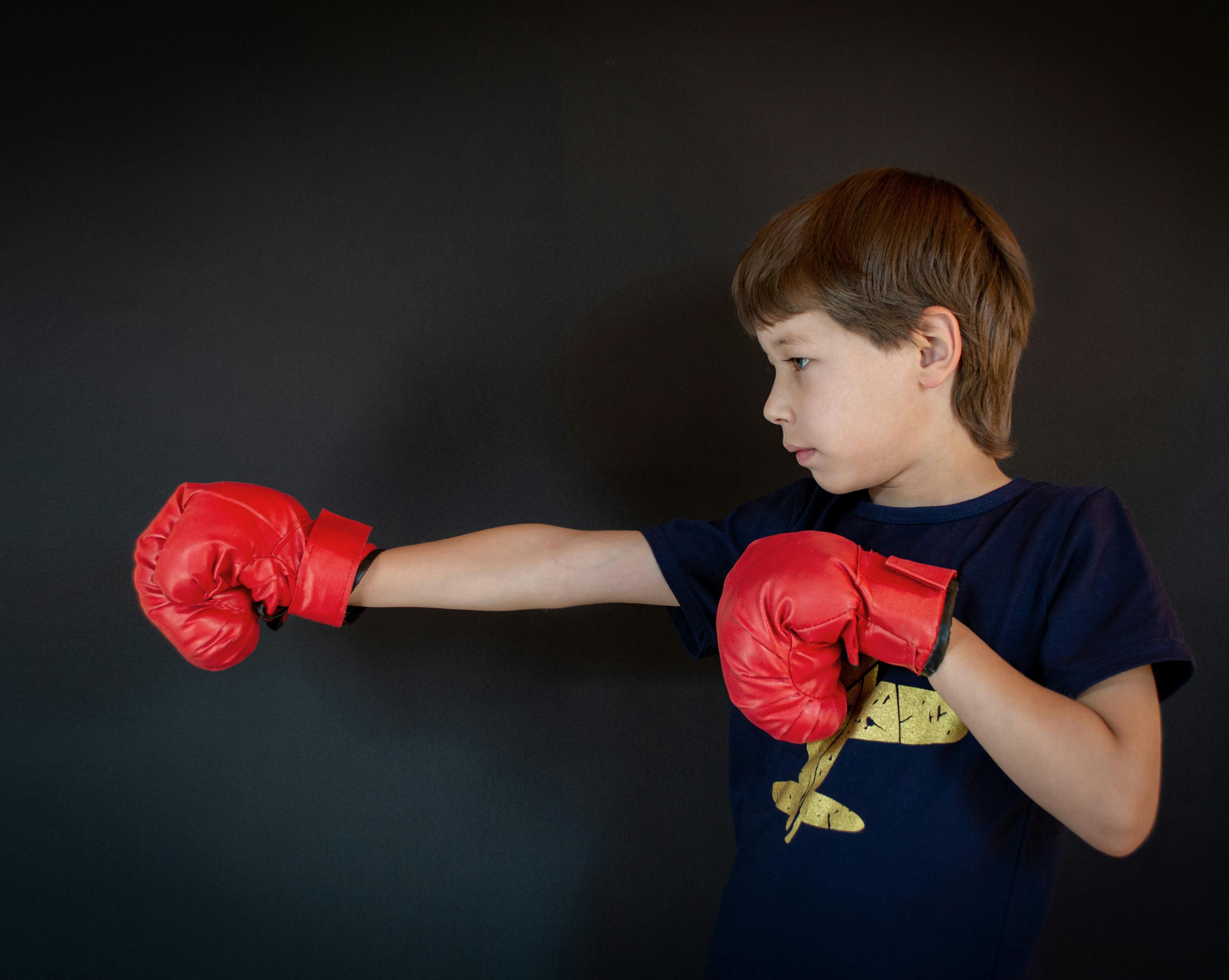 child demonstrating a proper boxing stance - boxing training for kids