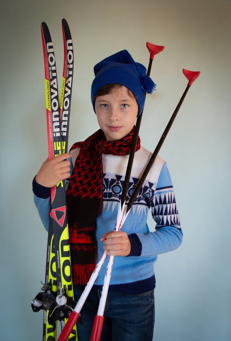 Boy With Scarf Holding Skiing Equipment