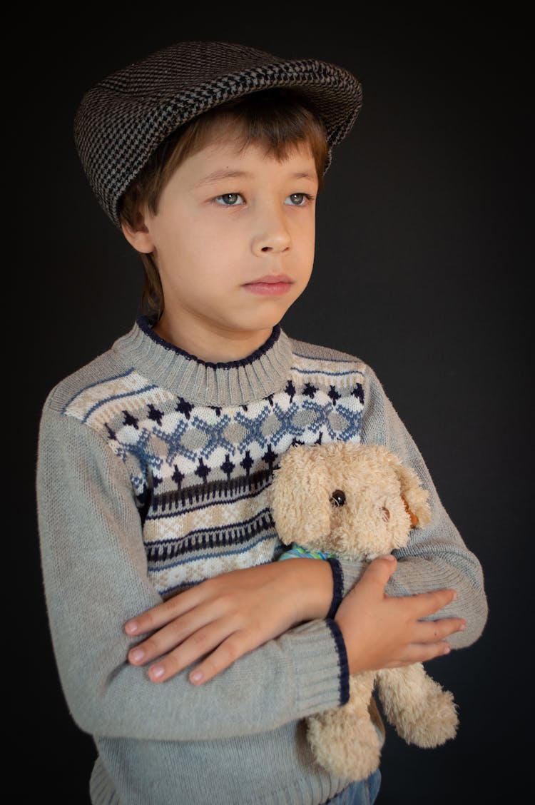 Boy In Gray Sweater Holding Brown Bear Plush Toy