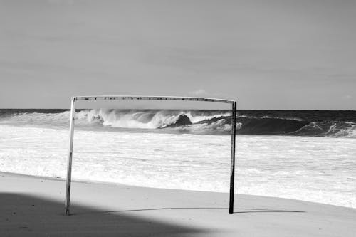 Grayscale Photo Wooden Bar Near Crashing Ocean Waves