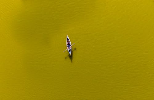 Aerial Photography of People Riding a Boat on the River