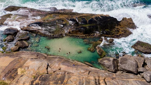 Brown Rock Formation Beside Body of Water