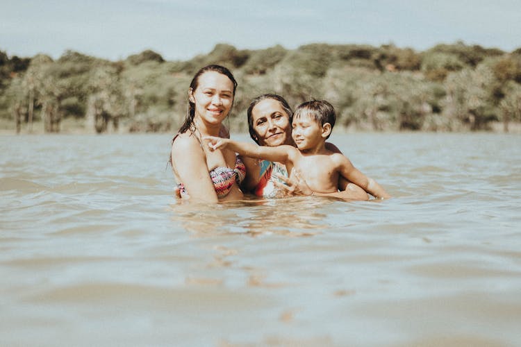 A Family Swimming On The Lake