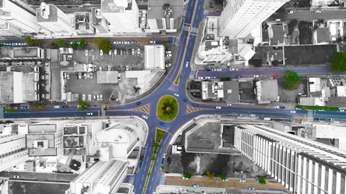 Aerial View of City Buildings and Asphalt Road