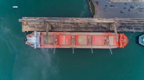 Free Drone shot of cargo ship docked at São Francisco do Sul harbor, showcasing maritime activity from above. Stock Photo