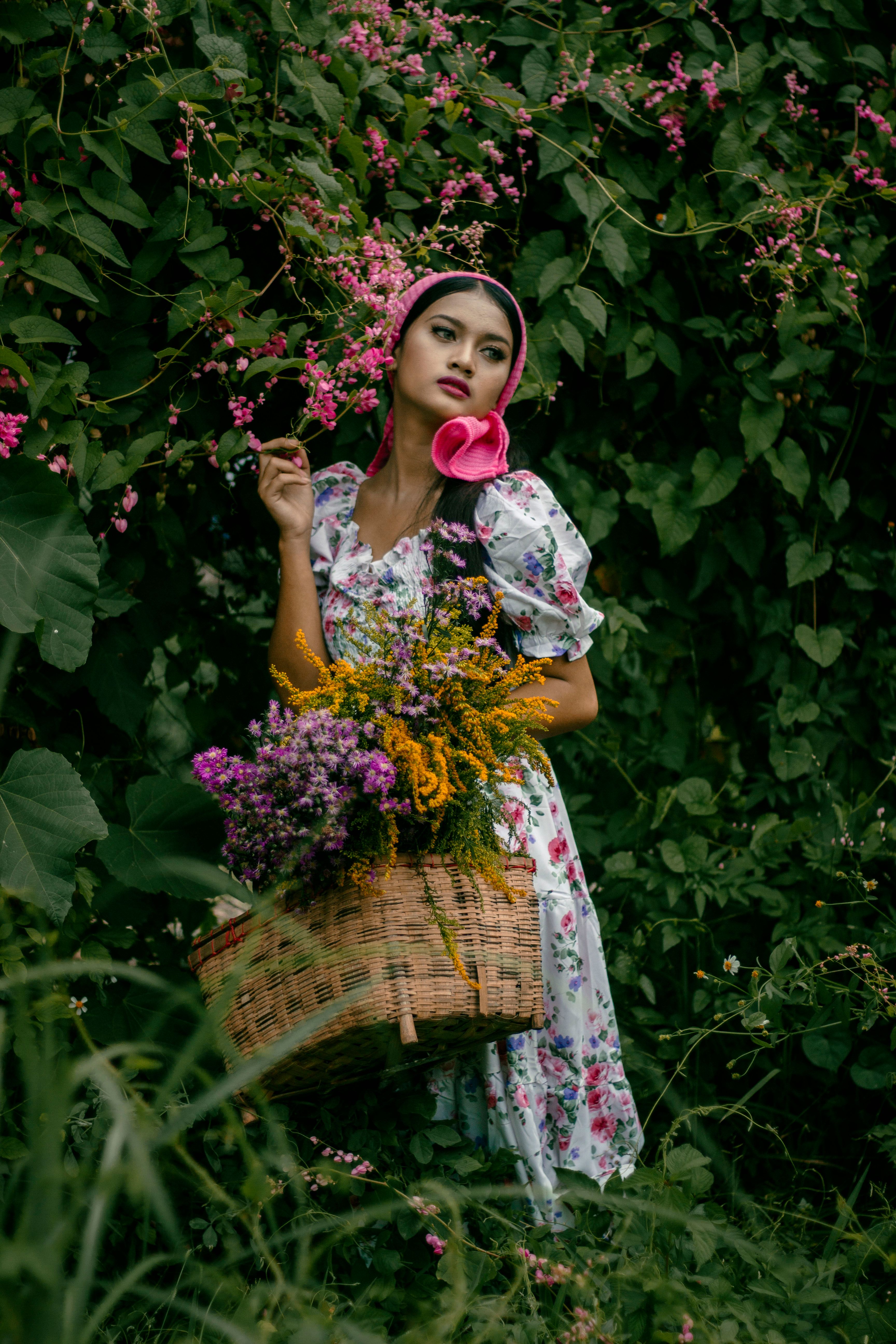 Woman Wearing a Floral Dress Carrying a Basket of Flowers · Free Stock ...
