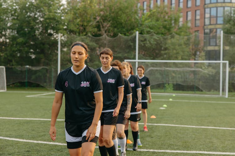 Group Of Women Playing Football 