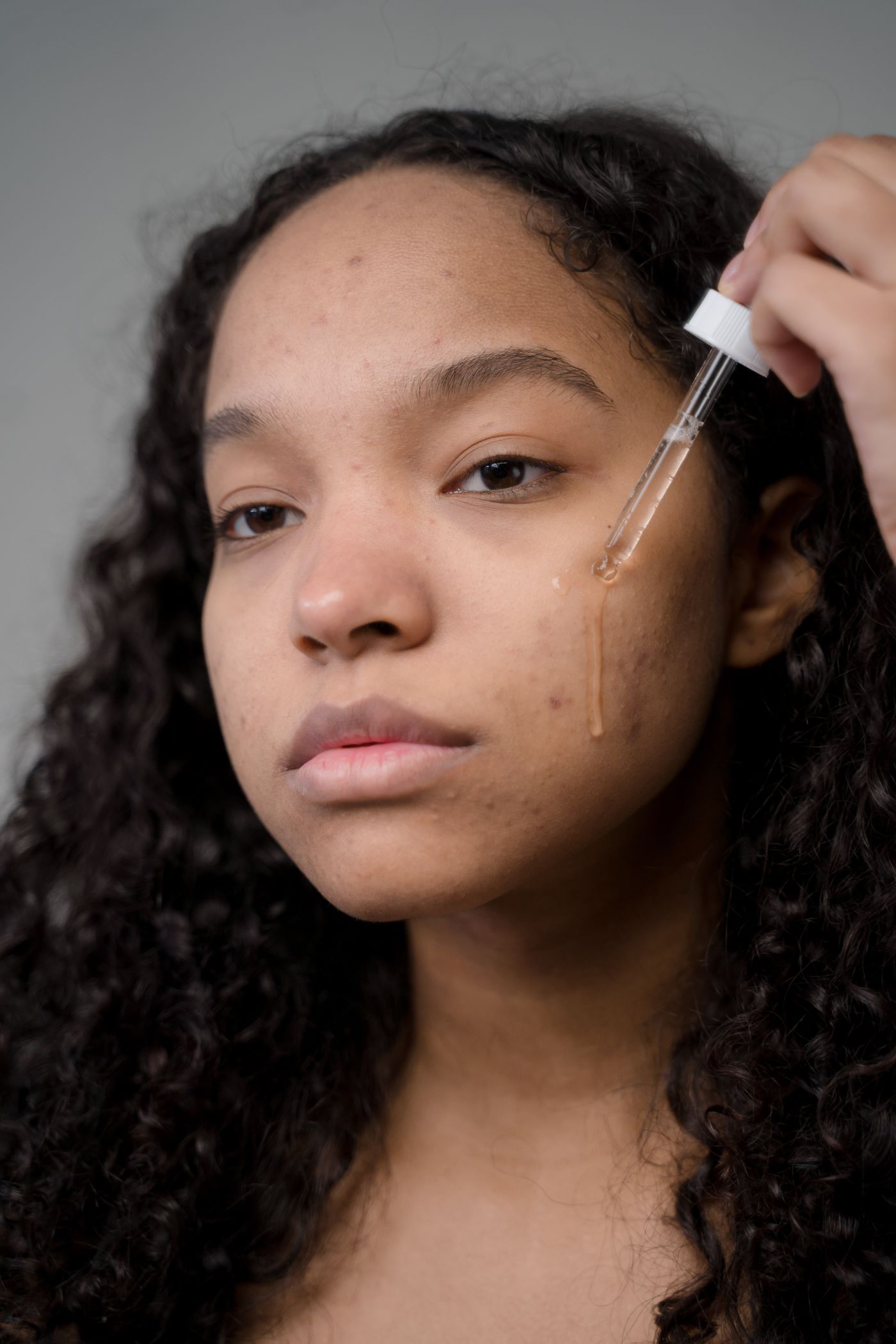 Woman applying skincare serum