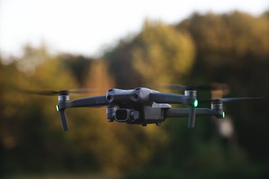 A close-up of a drone flying against a forest backdrop, showcasing motion and technology.