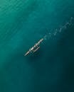 People Paddling an Outrigger Canoe in the Blue Ocean